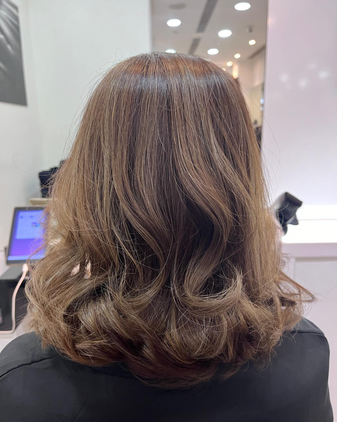 The back profile of a woman's short curled hair